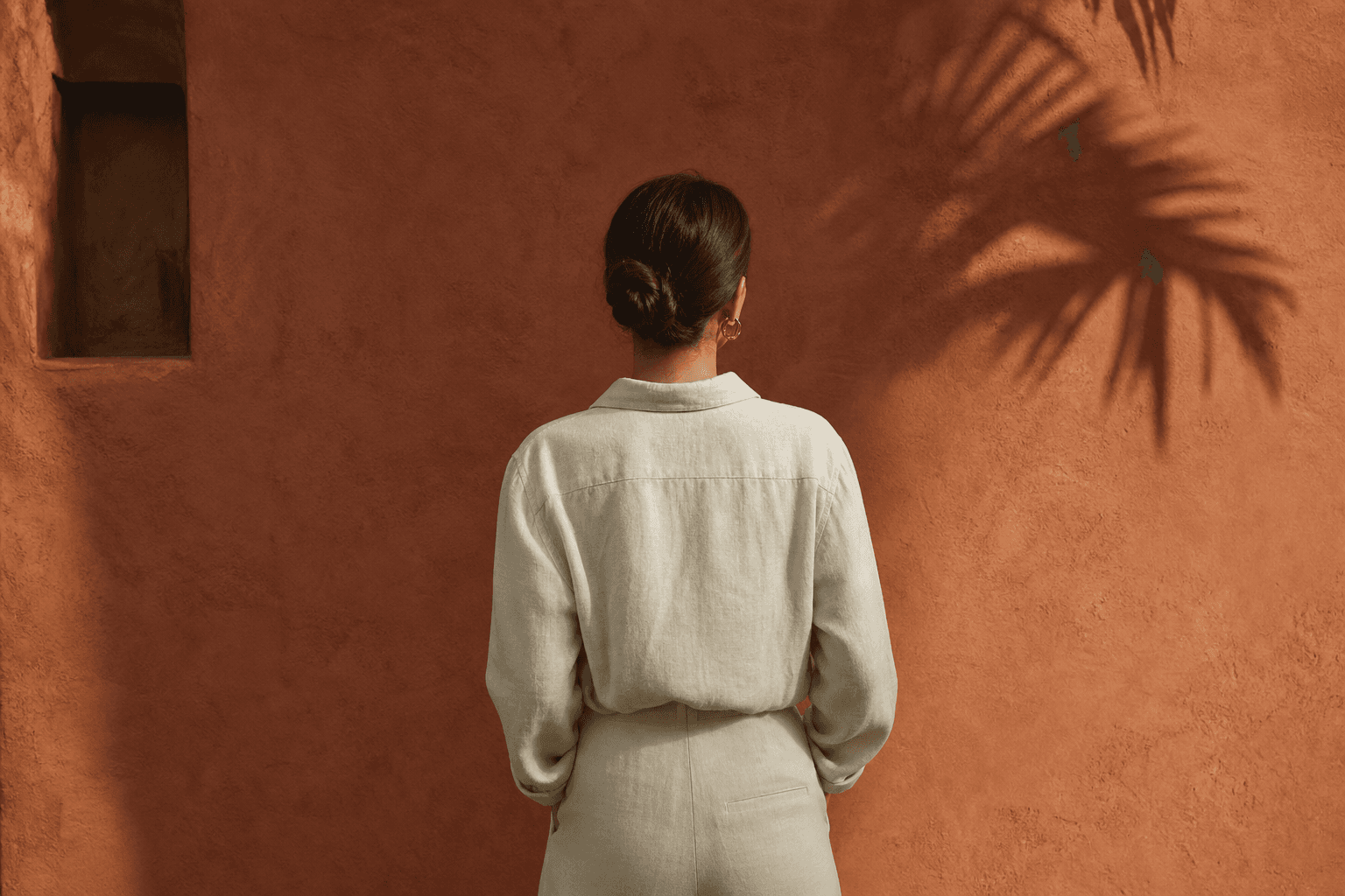 Bianca against a terracotta wall